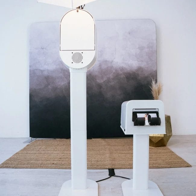 Photo booth setup with a modern gray backdrop at an Ann Arbor event