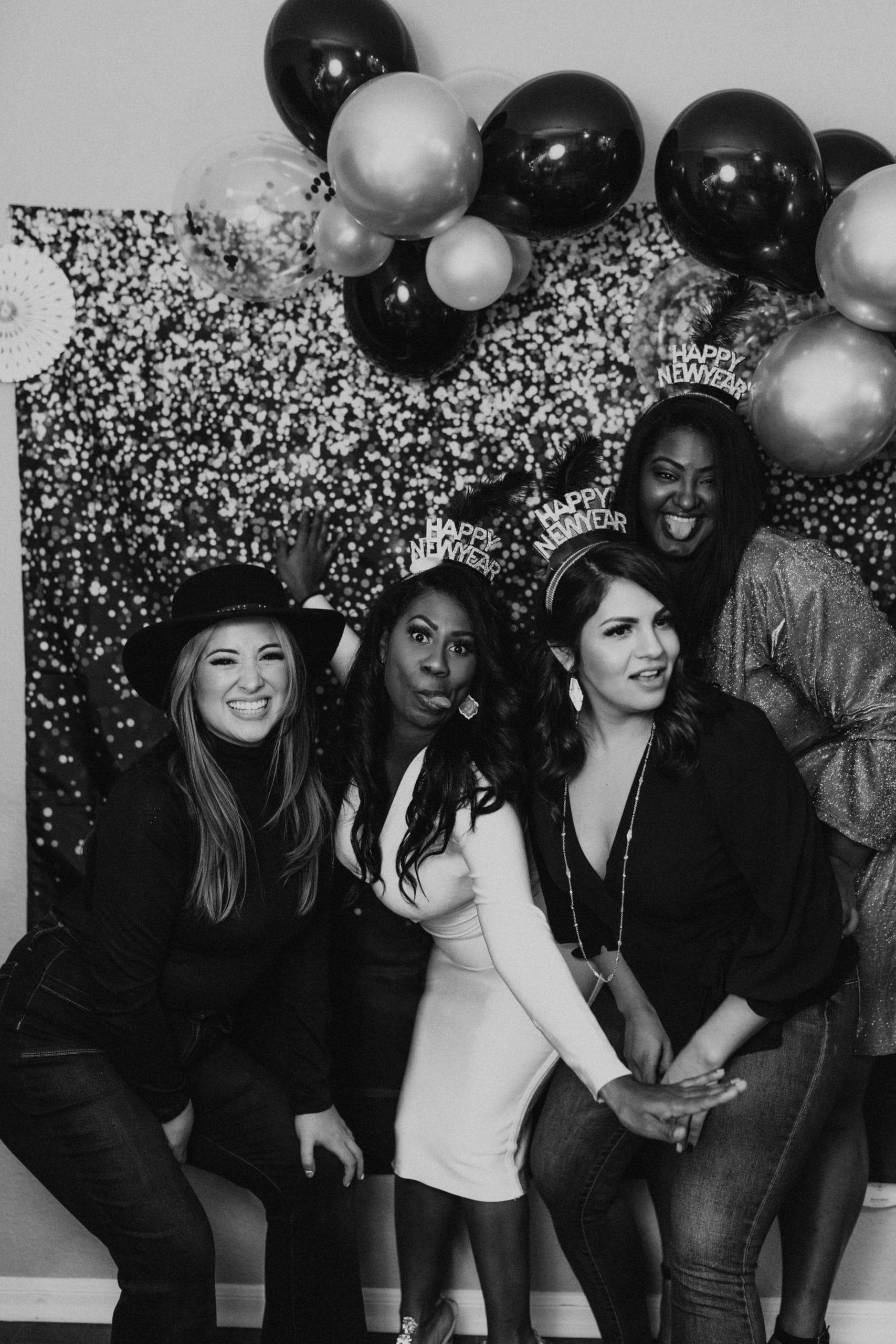 Group of guests celebrating New Year’s Eve in a photo booth in Ann Arbor